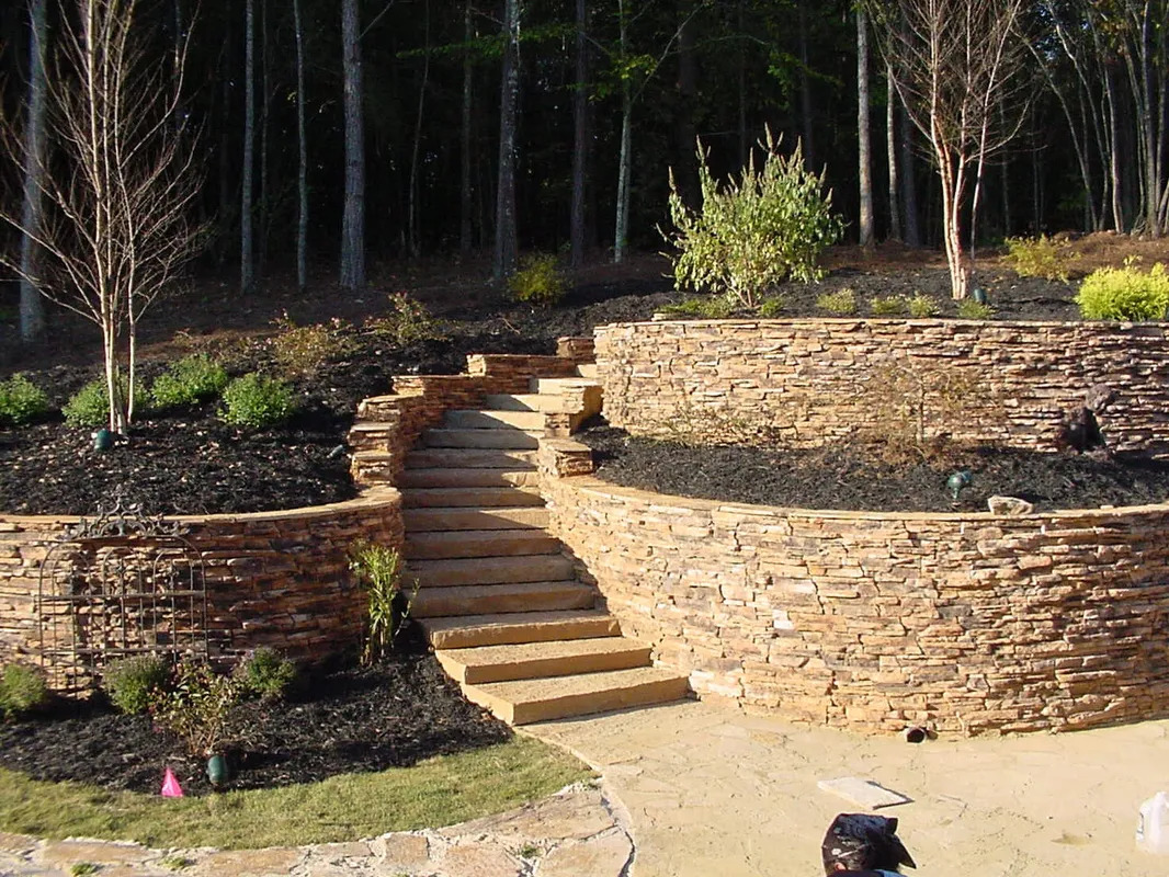 Curved stone retaining wall with steps in Cherokee County, GA