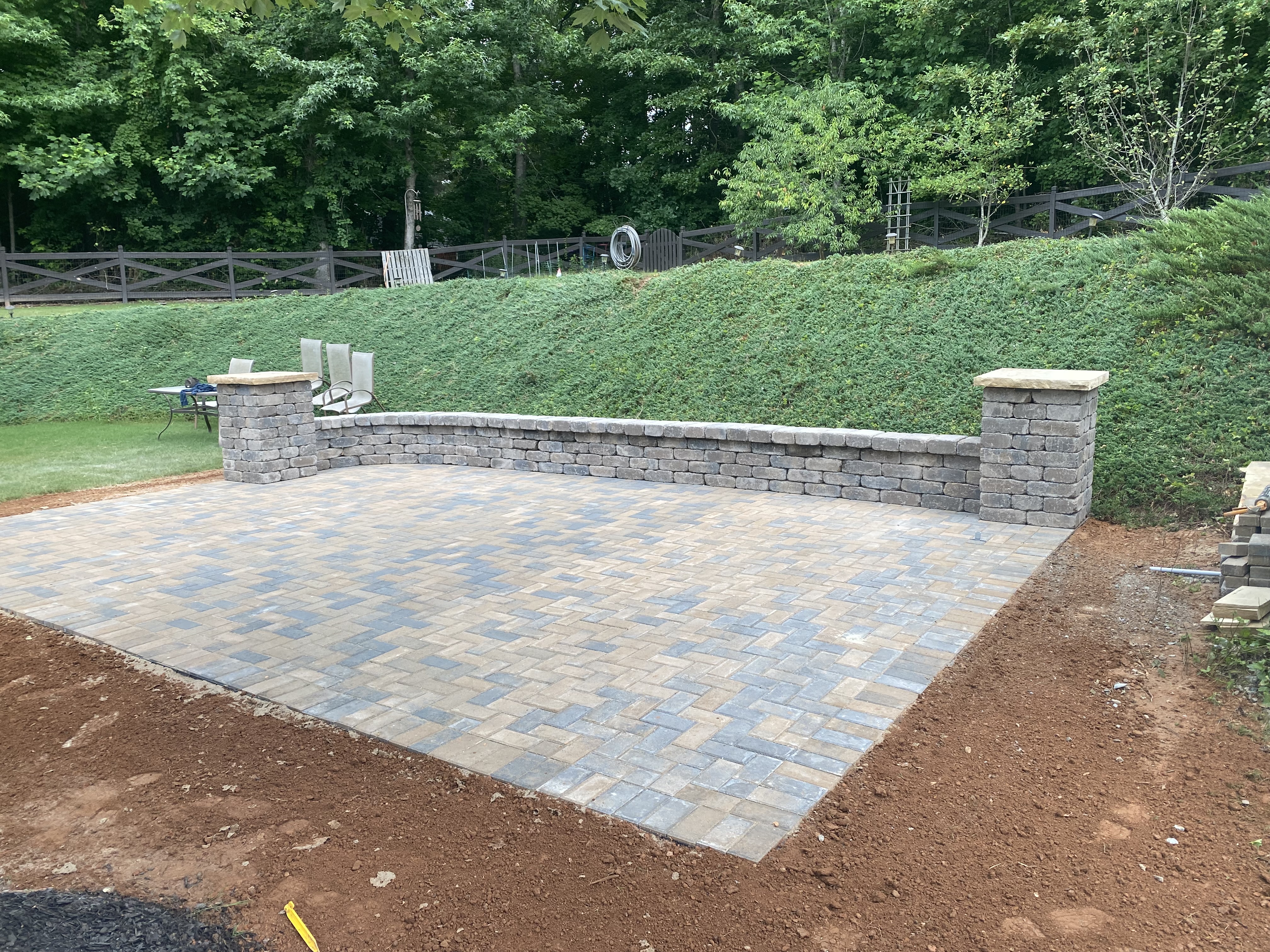 Paver patio with stone seat wall and columns in Woodstock, GA