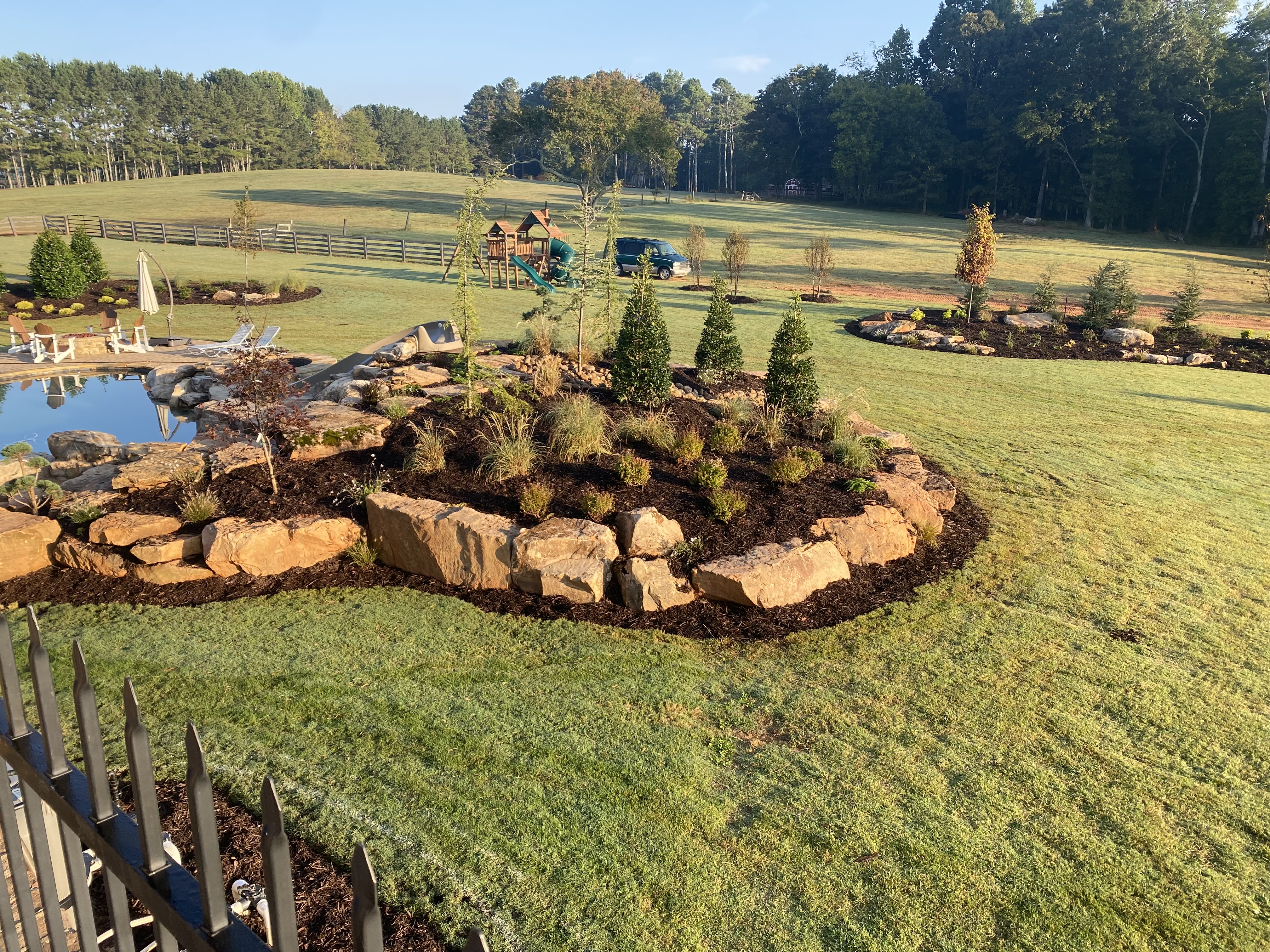 Aerial view of boulder landscape bed with pond in Cherokee County, GA