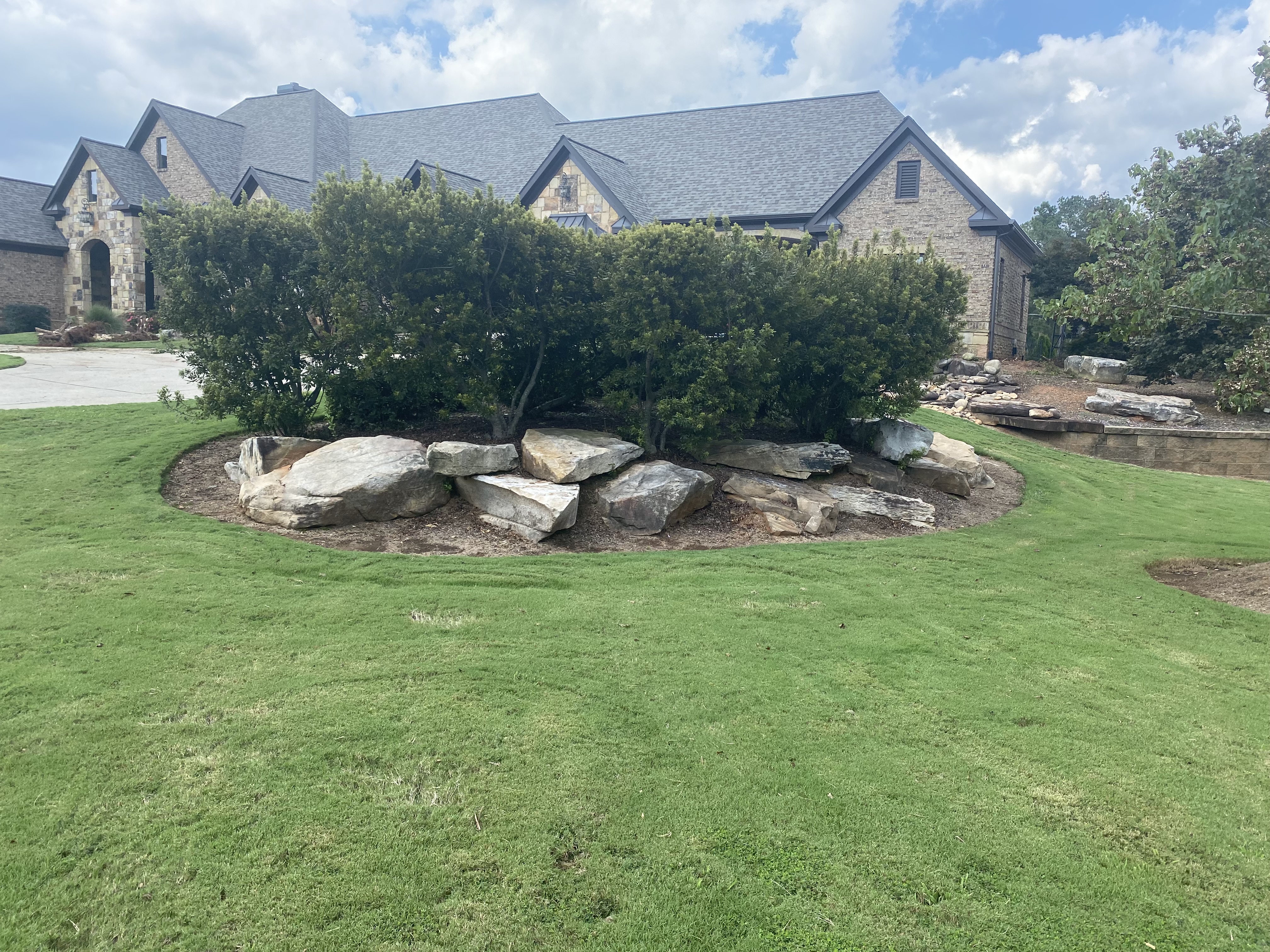 Boulder edging around tree in Cherokee County, GA