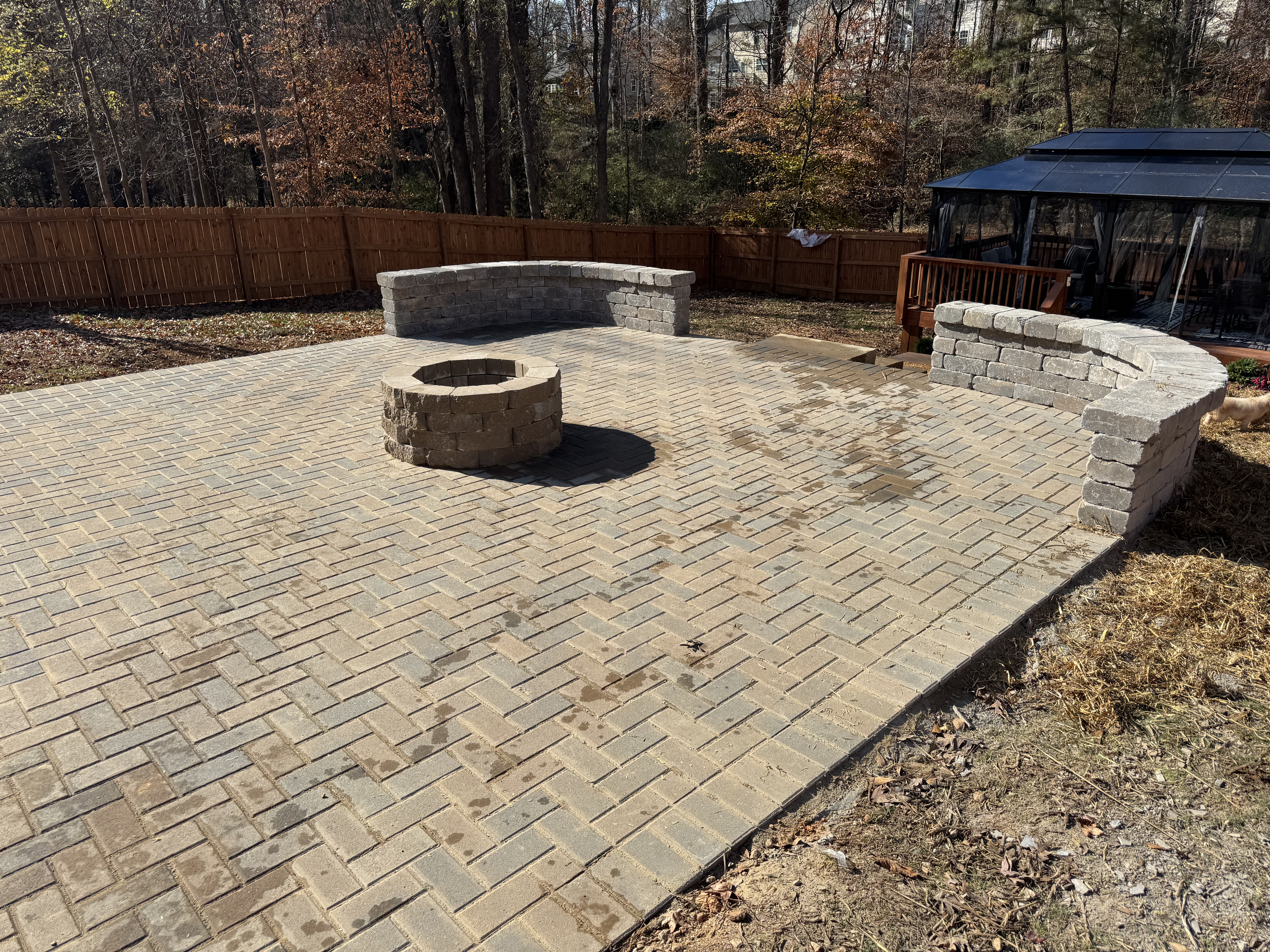Paver patio with fire pit and curved seat wall in Cherokee County, GA