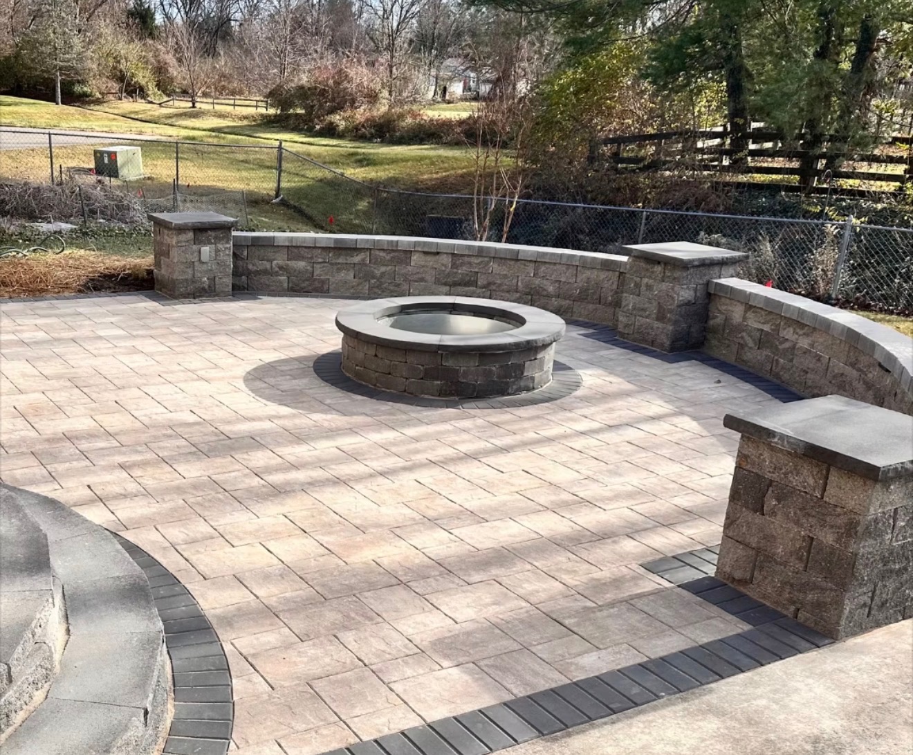 Paver patio with fire pit and stone seat wall in North Atlanta, GA