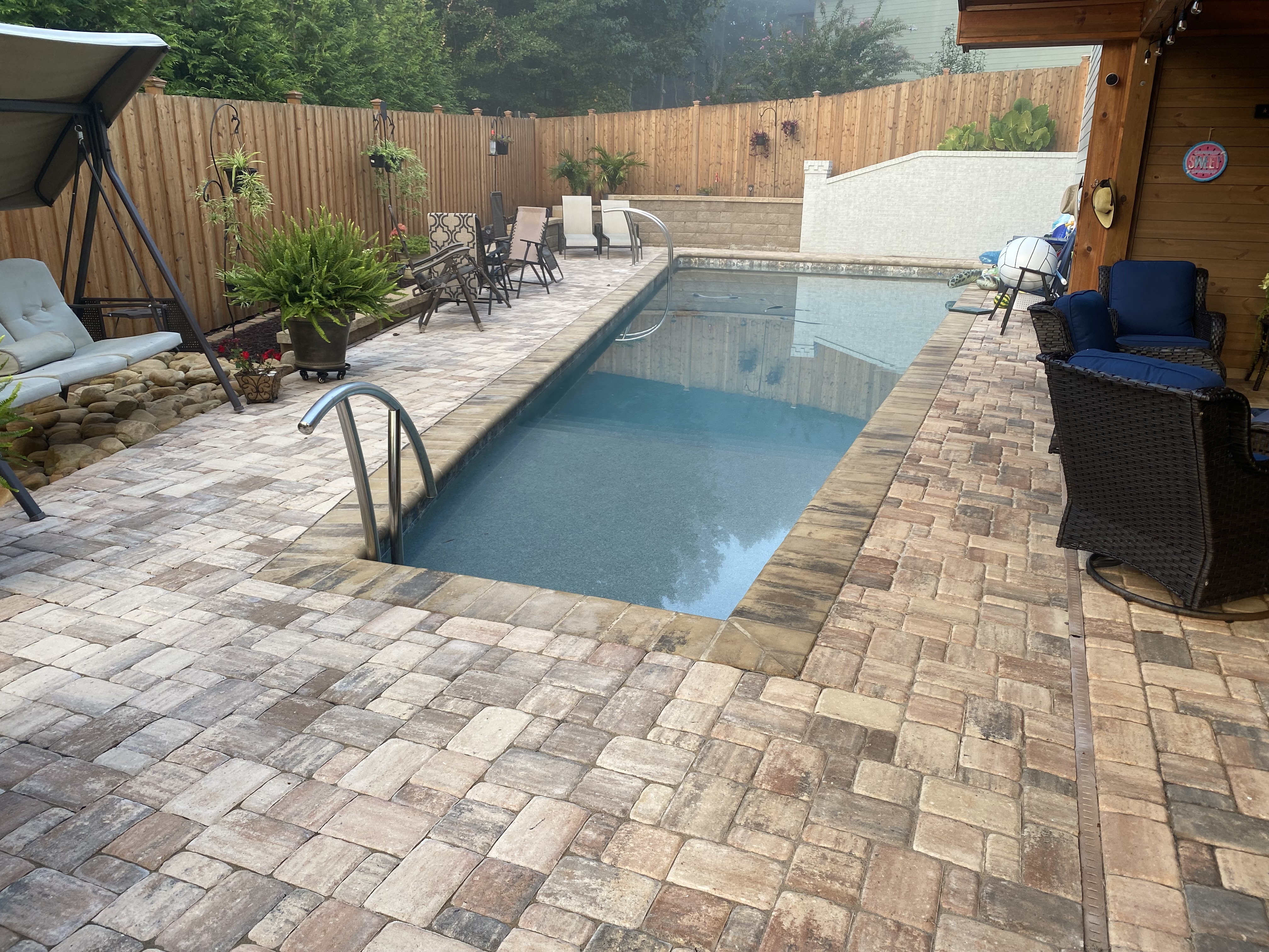 Paver pool deck with outdoor living area in North Atlanta, GA