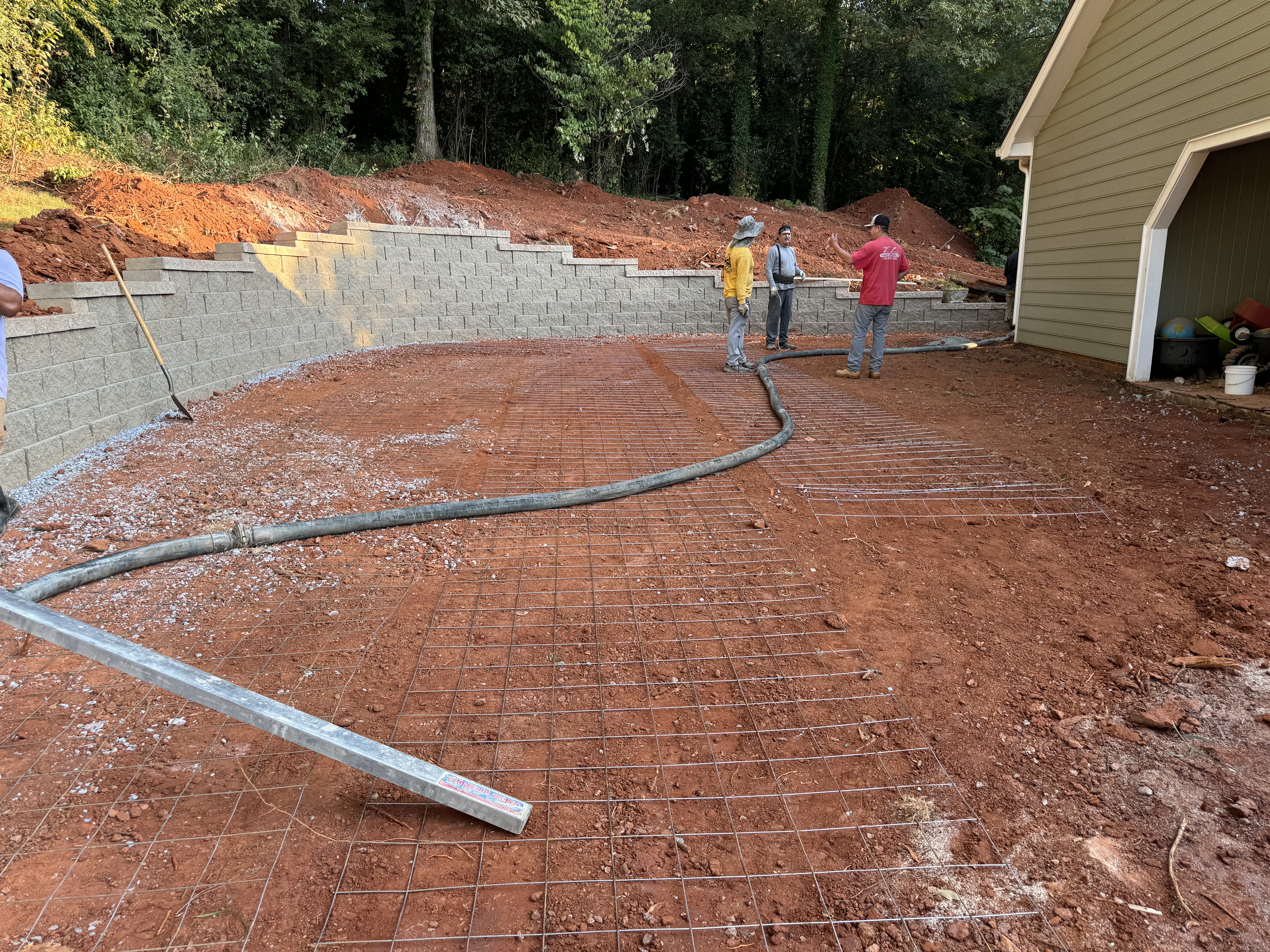 Concrete pour with rebar grid and block retaining wall in Cherokee County, GA