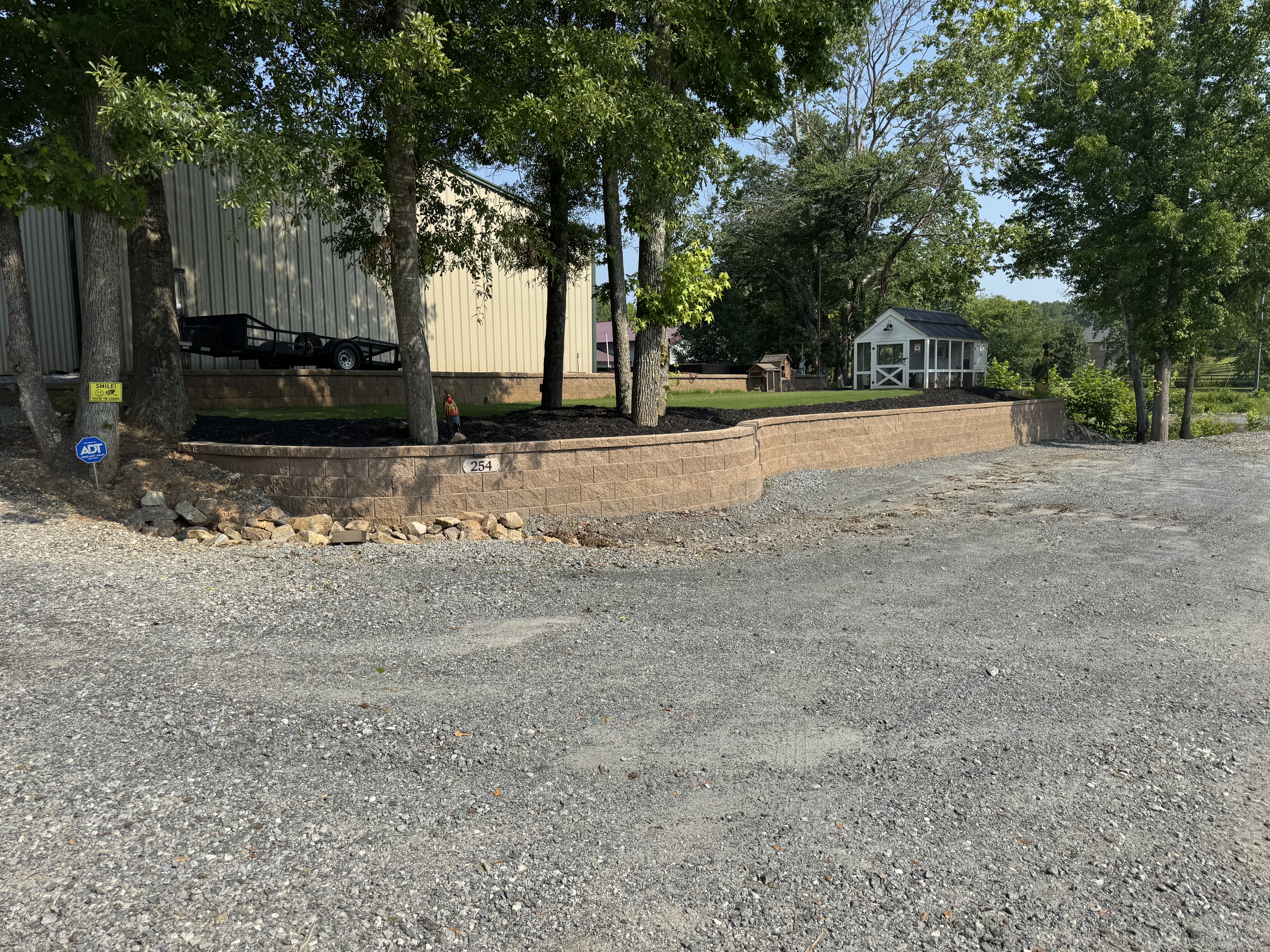 Block retaining wall with gravel driveway in North Atlanta, GA